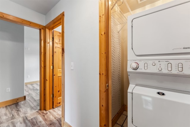 80 Cove Blvd Unit 103, Dillon, CO 80435 - laundry room with estacked washer and dryer, light wood-style flooring, and baseboards