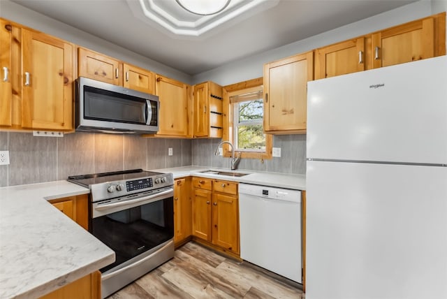 80 Cove Blvd Unit 103, Dillon, CO 80435 - kitchen with appliances with stainless steel finishes, a sink, light countertops, and light wood-type flooring
