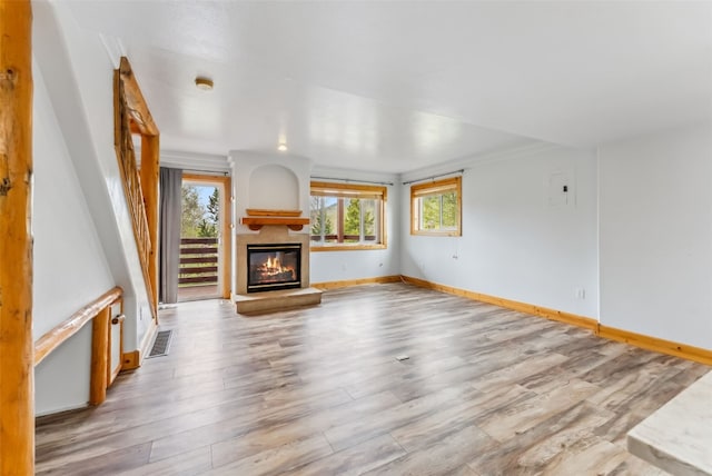80 Cove Blvd Unit 103, Dillon, CO 80435 - unfurnished living room with a glass covered fireplace, baseboards, and wood finished floors