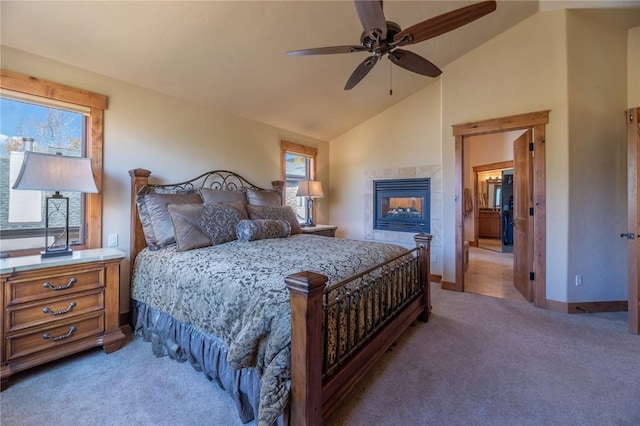 2206 Hamilton Creek Rd, Silverthorne, CO 80498 - bedroom with light carpet, vaulted ceiling, a tiled fireplace, and a ceiling fan