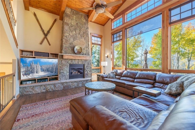 2206 Hamilton Creek Rd, Silverthorne, CO 80498 - living room with wooden ceiling with exposed beams, ceiling fan, wood-type flooring, high vaulted ceiling, and a stone fireplace