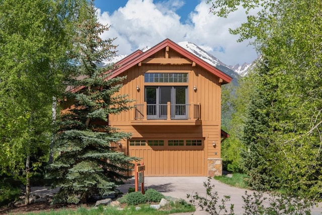 2206 Hamilton Creek Rd, Silverthorne, CO 80498 - view of front of property featuring an attached garage, driveway, stone siding, and board and batten siding