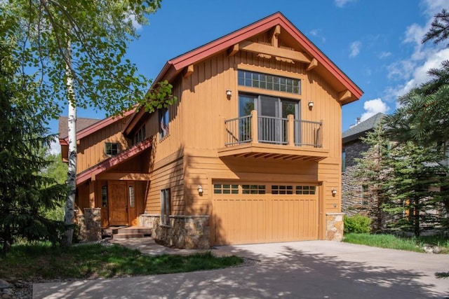 2206 Hamilton Creek Rd, Silverthorne, CO 80498 - rustic home with a balcony, stone siding, concrete driveway, and board and batten siding