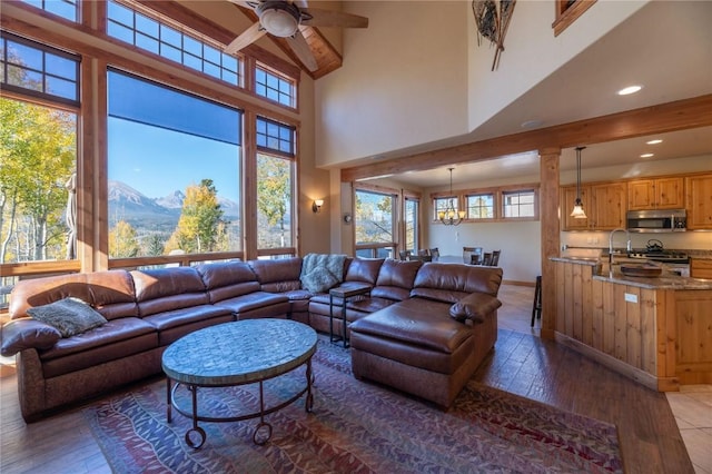 2206 Hamilton Creek Rd, Silverthorne, CO 80498 - living area with a ceiling fan, hardwood / wood-style floors, a mountain view, a high ceiling, and recessed lighting