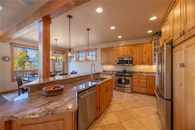 2206 Hamilton Creek Rd, Silverthorne, CO 80498 - kitchen featuring stainless steel appliances, a sink, beamed ceiling, a center island with sink, and healthy amount of natural light