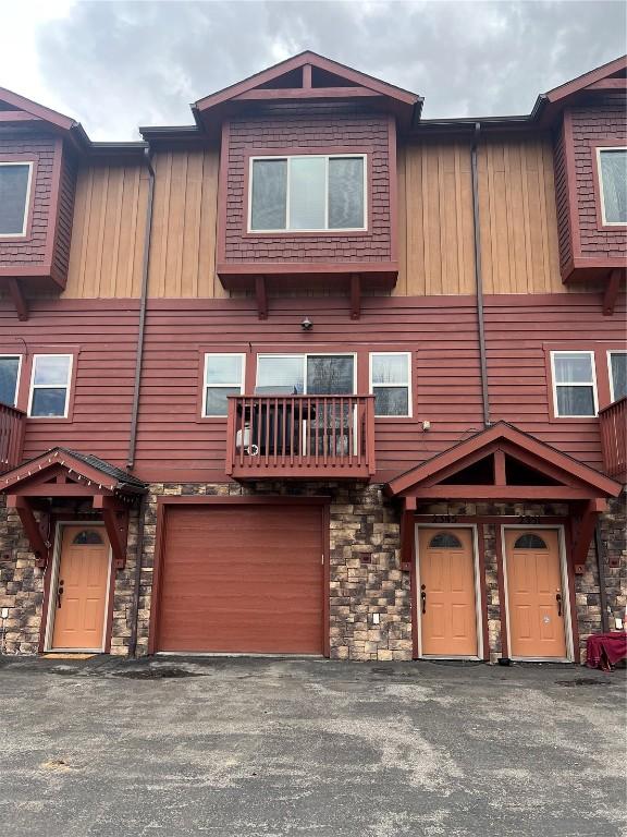 2345 Abbey Ct SW Unit 3, Steamboat Springs, CO 80487 - view of front of home with a garage, driveway, stone siding, and board and batten siding