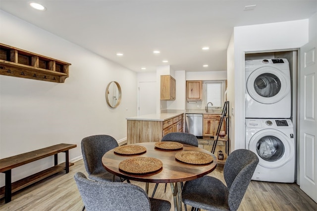 dining room with stacked washer and dryer, baseboards, recessed lighting, and light wood-style floors