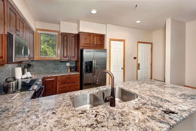22138 US Highway 6 Unit 1560, Keystone, CO 80435 - kitchen with stainless steel appliances, light stone countertops, a sink, tasteful backsplash, and recessed lighting