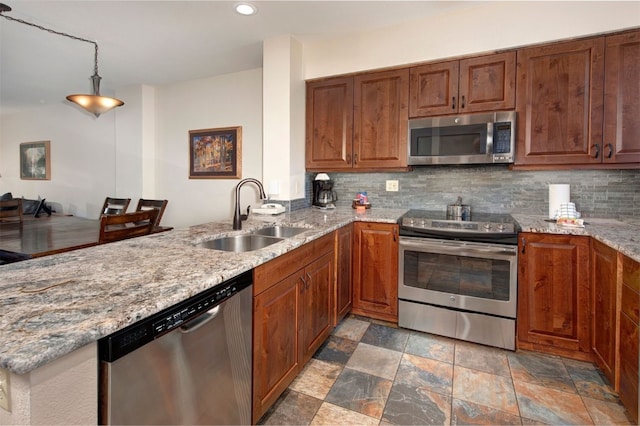 22138 US Highway 6 Unit 1560, Keystone, CO 80435 - kitchen featuring appliances with stainless steel finishes, a sink, a peninsula, decorative backsplash, and recessed lighting