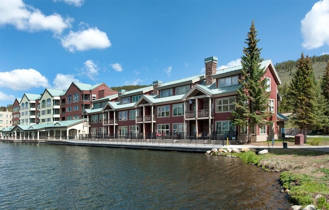 22138 US Highway 6 Unit 1560, Keystone, CO 80435 - back of house featuring a chimney, a standing seam roof, metal roof, and a water view