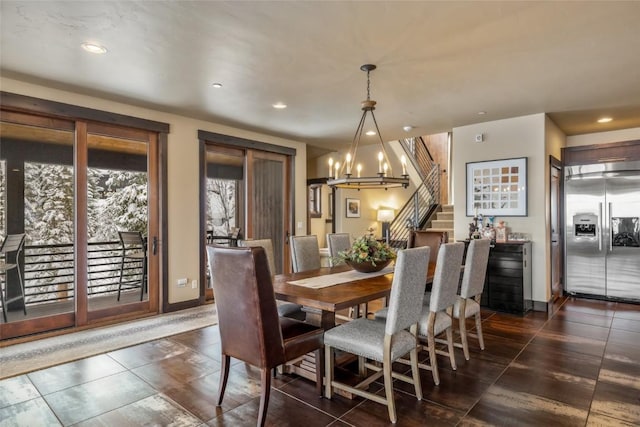 dining room featuring stairs, a chandelier, and recessed lighting