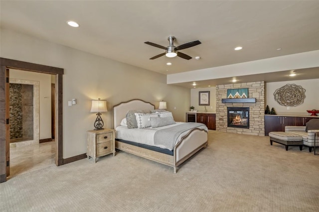 bedroom with recessed lighting, a fireplace, baseboards, and light colored carpet