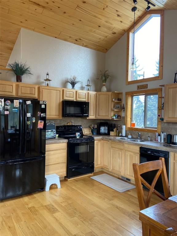 56 Apache Trl, Como, CO 80432 - kitchen featuring black appliances, light brown cabinets, wooden ceiling, light wood finished floors, and tasteful backsplash