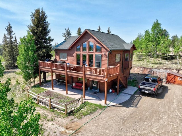 56 Apache Trl, Como, CO 80432 - rear view of property featuring a deck, a patio area, and a shingled roof