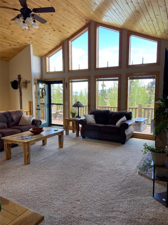56 Apache Trl, Como, CO 80432 - carpeted living area with wooden ceiling, plenty of natural light, high vaulted ceiling, and a ceiling fan