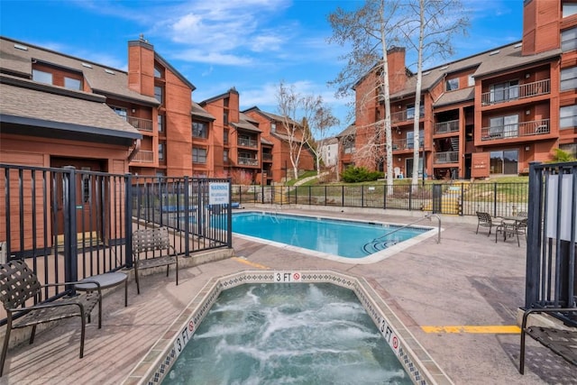 2015 Walton Creek Rd Unit 114, Steamboat Springs, CO 80487 - community pool featuring a community hot tub, a patio area, and fence