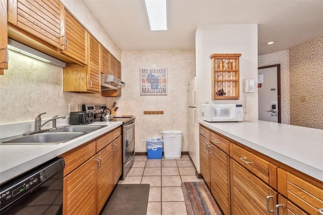 2015 Walton Creek Rd Unit 114, Steamboat Springs, CO 80487 - kitchen with a sink, light countertops, under cabinet range hood, wallpapered walls, and white appliances