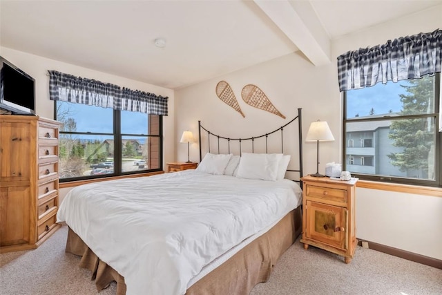 2015 Walton Creek Rd Unit 114, Steamboat Springs, CO 80487 - bedroom with baseboards, multiple windows, and light colored carpet
