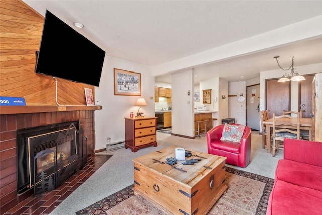 2015 Walton Creek Rd Unit 114, Steamboat Springs, CO 80487 - living room featuring a fireplace, baseboards, carpet floors, and a baseboard radiator