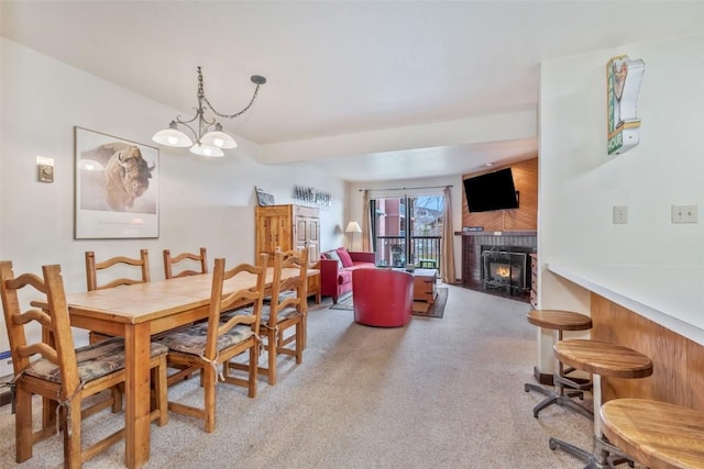 2015 Walton Creek Rd Unit 114, Steamboat Springs, CO 80487 - dining area featuring a brick fireplace, wooden walls, and light colored carpet