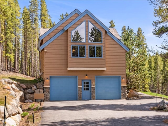 463 Blue Flag Cir, Breckenridge, CO 80424 - view of property exterior with stone siding, a garage, and driveway