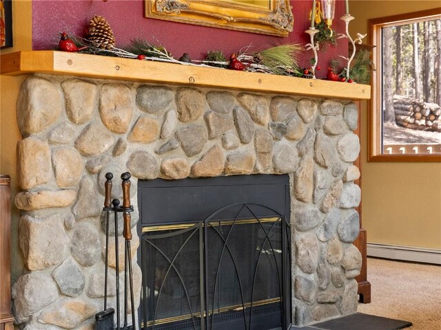 463 Blue Flag Cir, Breckenridge, CO 80424 - detailed view of a stone fireplace, baseboard heating, and carpet flooring