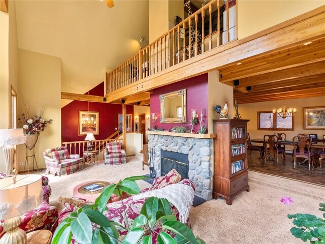 463 Blue Flag Cir, Breckenridge, CO 80424 - carpeted living room with a high ceiling, a chandelier, and a stone fireplace