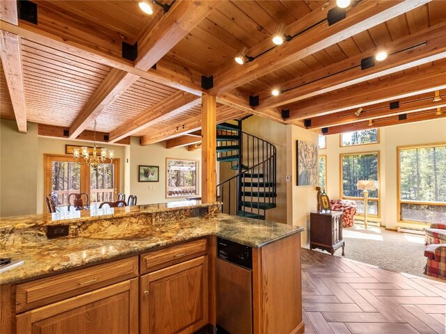463 Blue Flag Cir, Breckenridge, CO 80424 - kitchen featuring track lighting, a chandelier, brown cabinets, stone countertops, and wooden ceiling with exposed beams