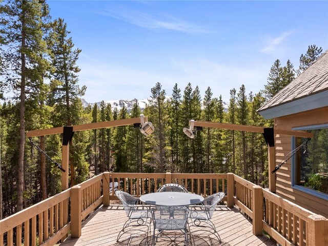 463 Blue Flag Cir, Breckenridge, CO 80424 - wooden terrace with outdoor dining space and a forest view