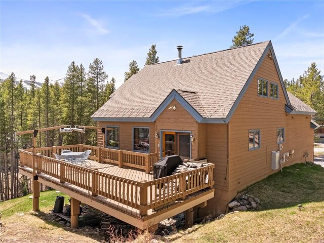 463 Blue Flag Cir, Breckenridge, CO 80424 - back of property with a shingled roof, a wooden deck, and a yard