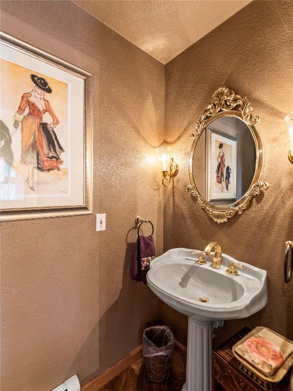463 Blue Flag Cir, Breckenridge, CO 80424 - bathroom with wood finished floors, a textured ceiling, baseboards, and a sink