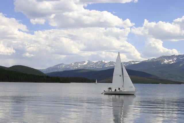 view of water feature featuring a dock and a mountain view