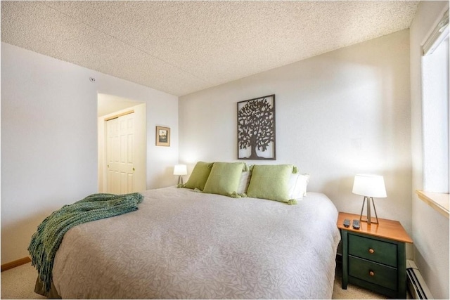 bedroom featuring carpet flooring, a textured ceiling, and a baseboard radiator