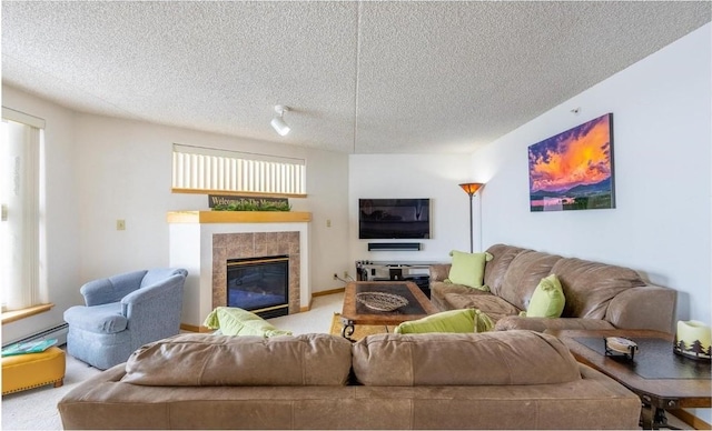 carpeted living room featuring a fireplace and a textured ceiling