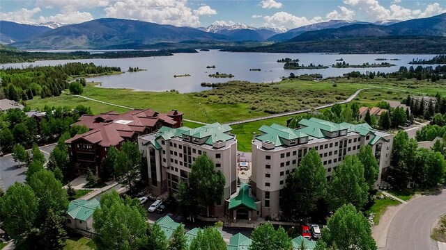 drone / aerial view featuring a water and mountain view