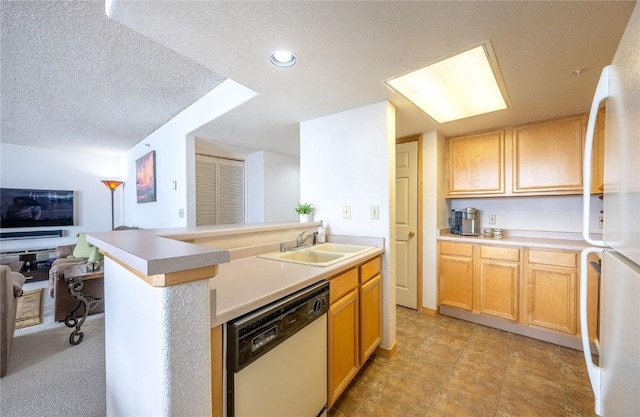 kitchen with a sink, a textured ceiling, open floor plan, white appliances, and light countertops