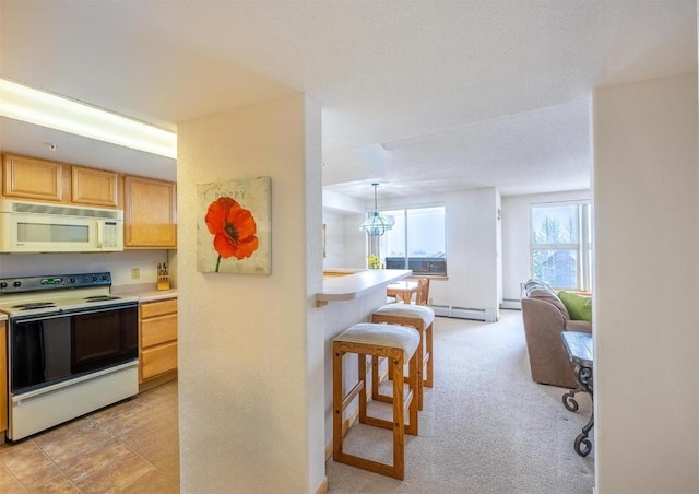 kitchen with light countertops, white appliances, baseboards, baseboard heating, and a breakfast bar area