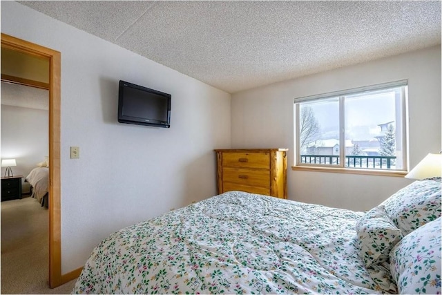 bedroom featuring carpet floors and a textured ceiling