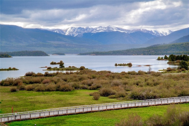 view of water feature featuring fence and a mountain view