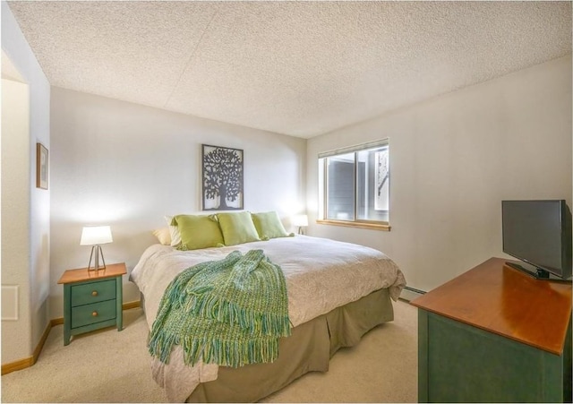 bedroom featuring baseboards, a textured ceiling, light colored carpet, and baseboard heating