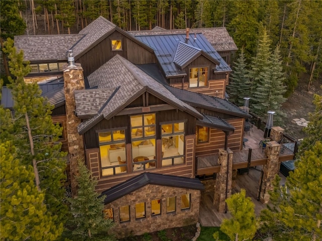 59 Mountain Bluebell Rd, Keystone, CO 80435 - rear view of property featuring a standing seam roof, roof with shingles, metal roof, a forest view, and a wooden deck