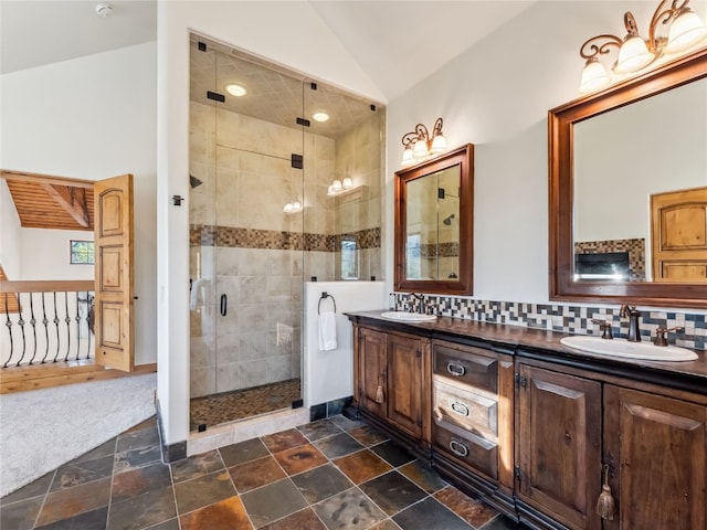 59 Mountain Bluebell Rd, Keystone, CO 80435 - full bath with double vanity, a shower stall, lofted ceiling, backsplash, and stone finish floors