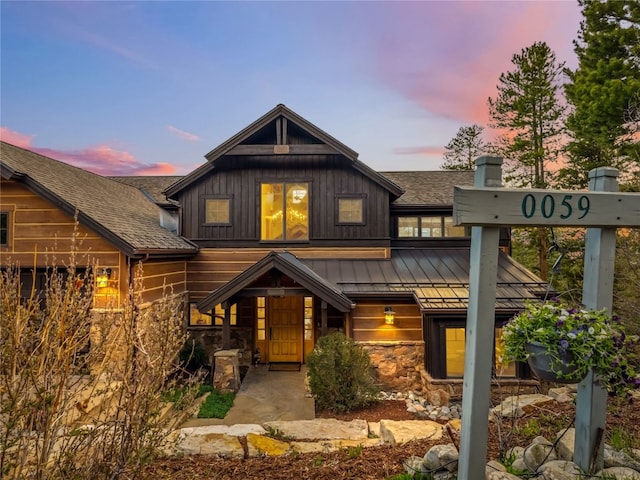 59 Mountain Bluebell Rd, Keystone, CO 80435 - view of front of home featuring a standing seam roof, stone siding, a shingled roof, and metal roof