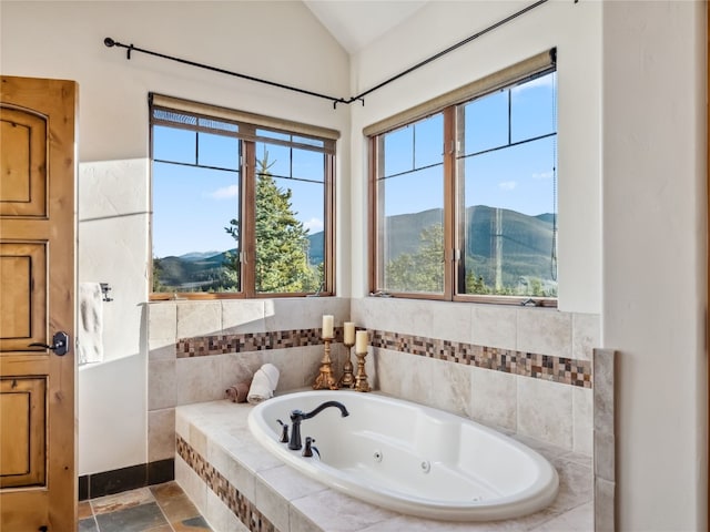 59 Mountain Bluebell Rd, Keystone, CO 80435 - bathroom featuring a jetted tub, a mountain view, and vaulted ceiling