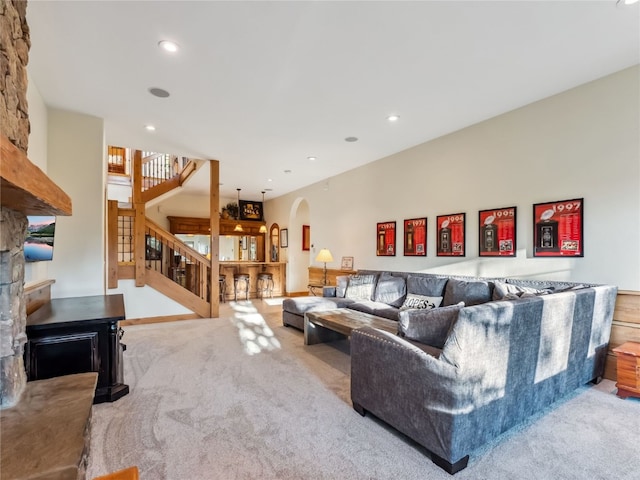 59 Mountain Bluebell Rd, Keystone, CO 80435 - living area featuring arched walkways, stairway, carpet floors, recessed lighting, and a stone fireplace