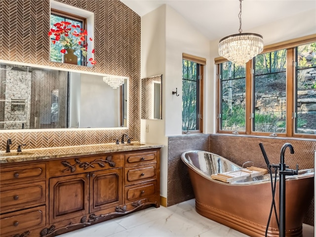 59 Mountain Bluebell Rd, Keystone, CO 80435 - full bathroom with healthy amount of natural light, a chandelier, a freestanding tub, double vanity, and vaulted ceiling