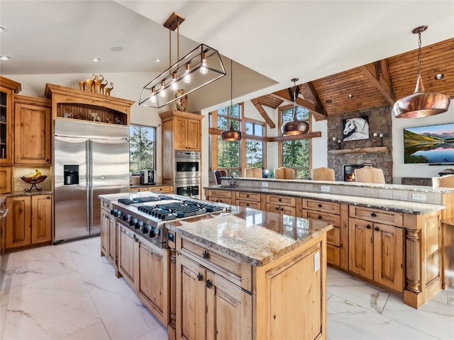 59 Mountain Bluebell Rd, Keystone, CO 80435 - kitchen with appliances with stainless steel finishes, a large island, light marble finish floors, a fireplace, and hanging light fixtures