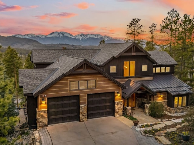 59 Mountain Bluebell Rd, Keystone, CO 80435 - view of front of property featuring a shingled roof, a mountain view, a standing seam roof, and concrete driveway