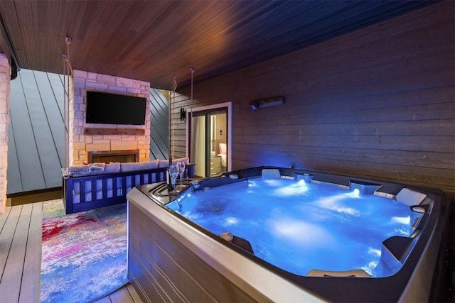 456 Forest Hills Dr, Breckenridge, CO 80424 - misc room featuring wood walls, an outdoor stone fireplace, wooden ceiling, and a hot tub