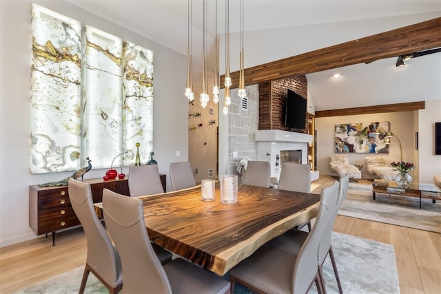 456 Forest Hills Dr, Breckenridge, CO 80424 - dining area with wood finished floors, a large fireplace, and lofted ceiling